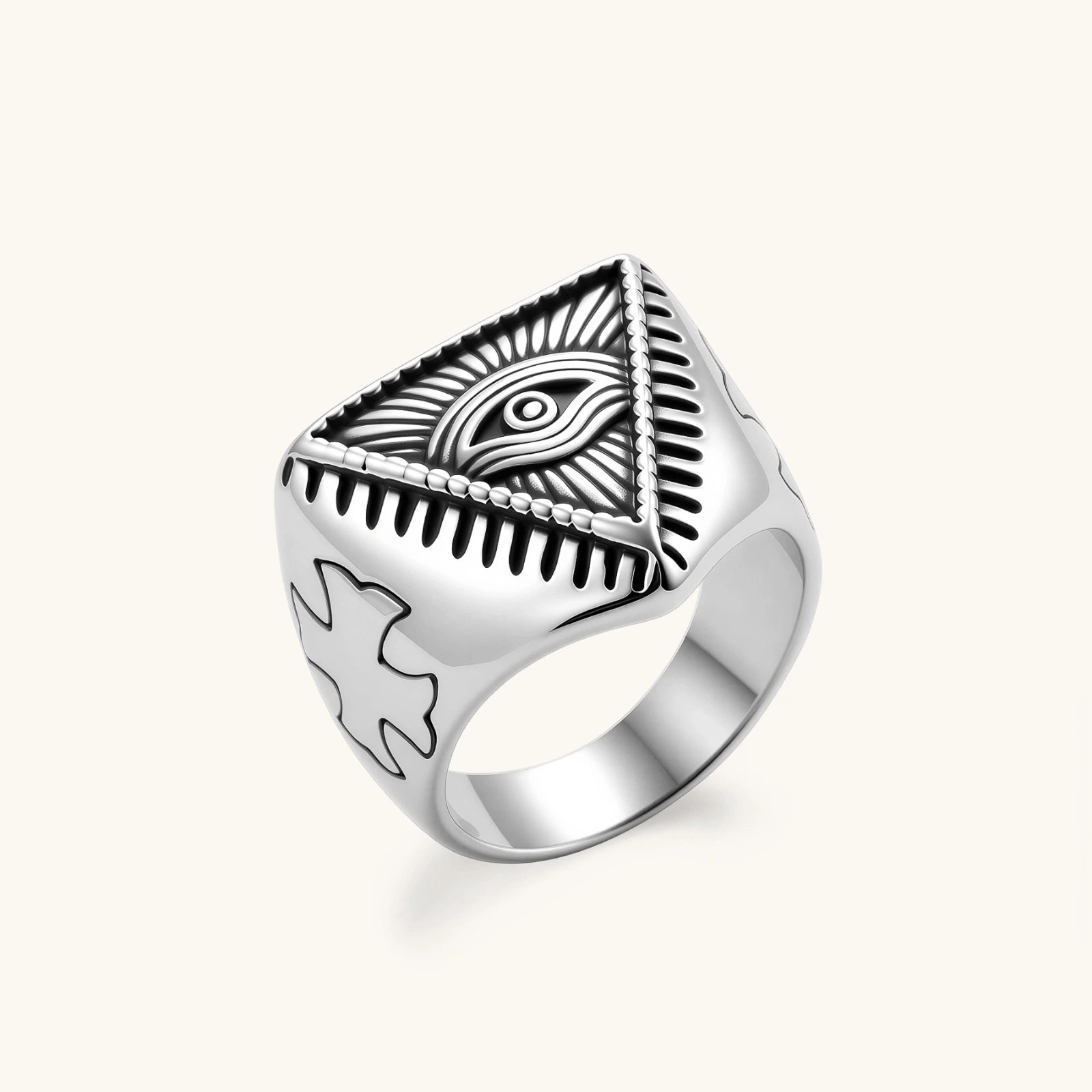 Silver stainless steel signet ring with engraved all-seeing eye in triangle, radiating lines, and cross motifs on the band.