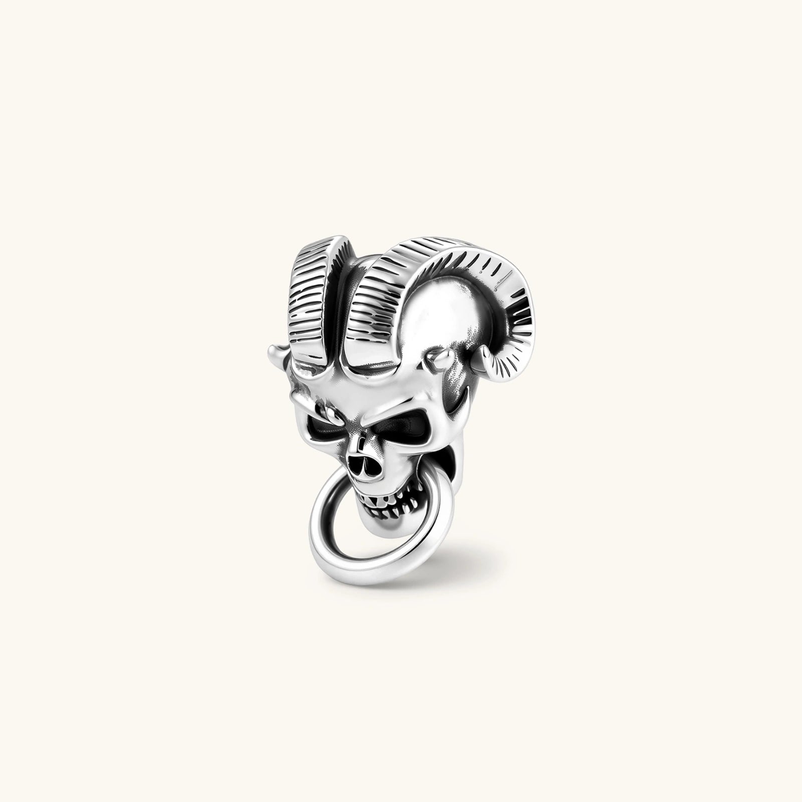 Silver 316L stainless steel stud earring shaped as a horned demon skull with ram horns and a dangling mouth ring.