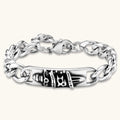 Silver 316L stainless steel Cuban chain bracelet with blackened skull and crown ID bar centerpiece, lobster clasp closure.