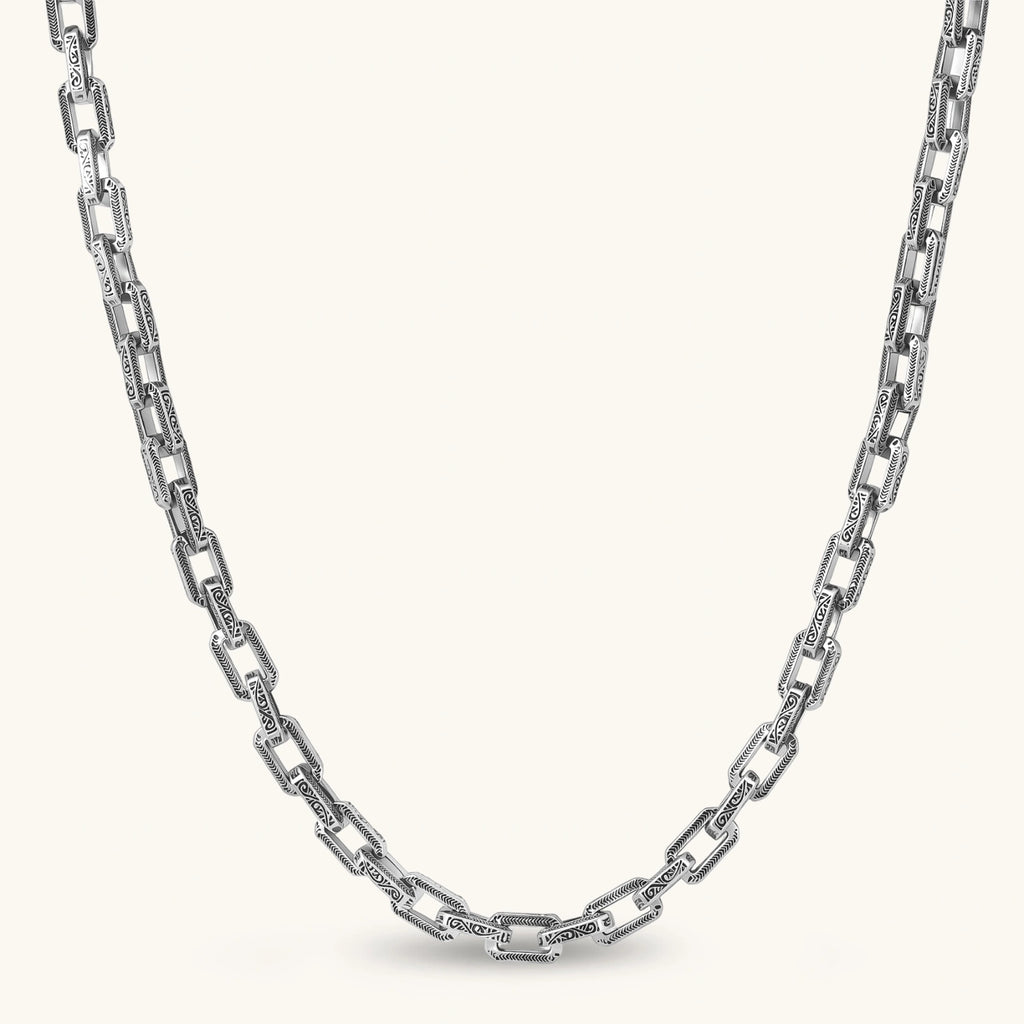 Silver 316L stainless steel rectangular link chain necklace with intricate scroll engravings, 560mm length, 7.1mm width.