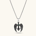 Silver stainless steel angel wing cross pendant necklace with green CZ center stone and black crystals on a box chain.