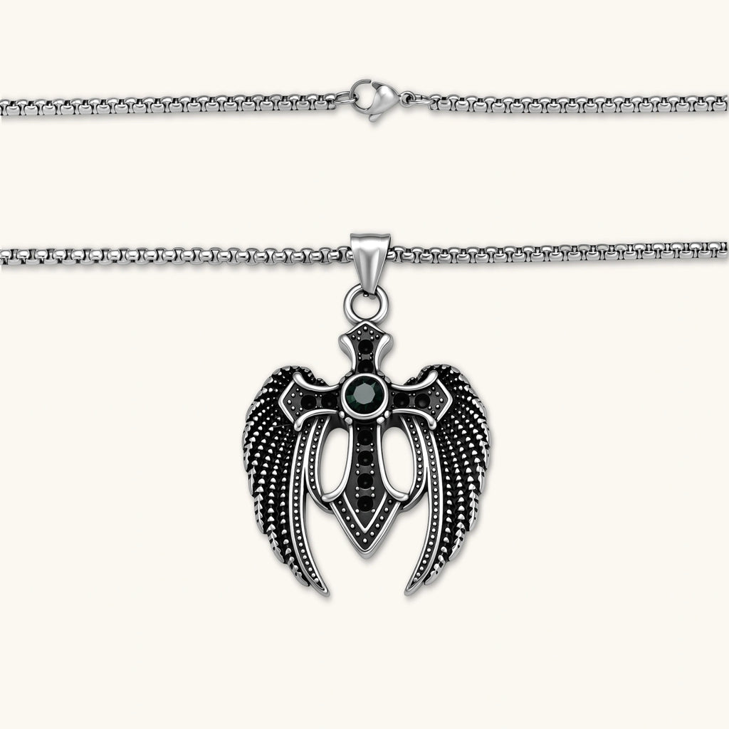 Silver stainless steel angel wing cross pendant necklace with green CZ center stone and black crystals on a box chain.