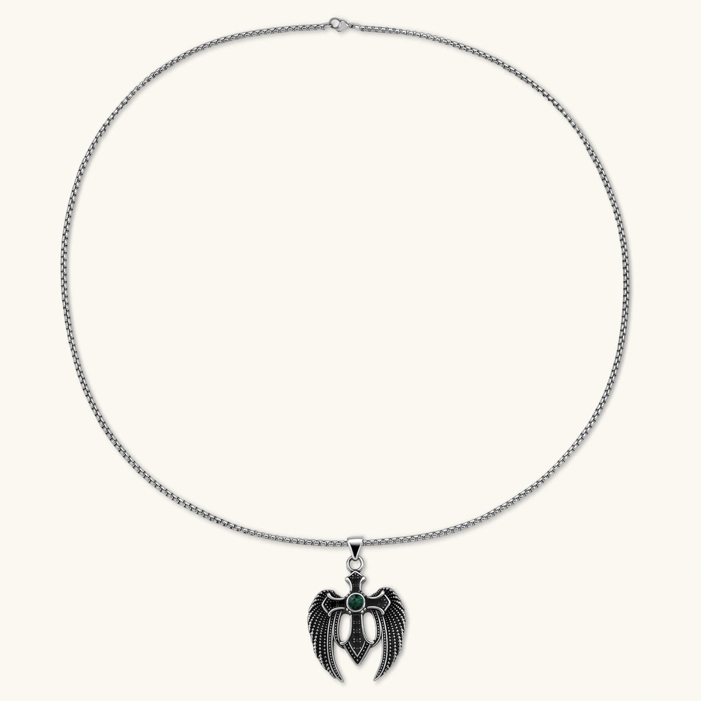 Silver stainless steel angel wing cross pendant necklace with green CZ center stone and black crystals on a box chain.