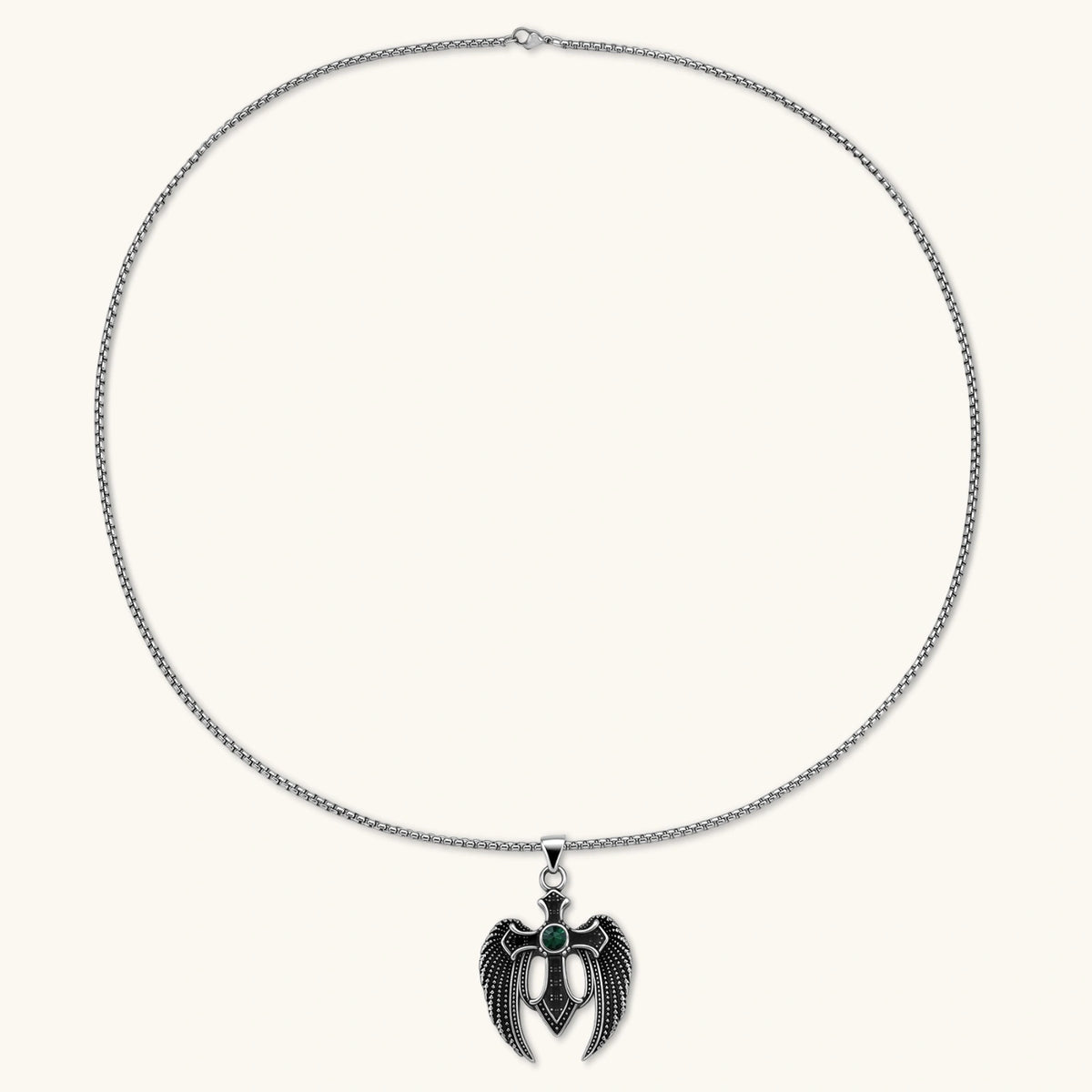 Silver stainless steel angel wing cross pendant necklace with green CZ center stone and black crystals on a box chain.