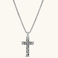 Silver stainless steel Celtic cross pendant with filigree vine pattern on a box chain, against a cream background.