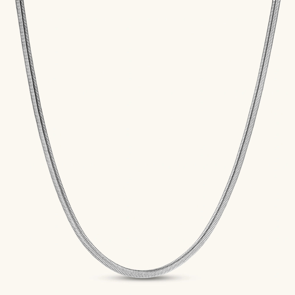 Two-tone twisted necklace with interlocked gold and silver ribbed snake chains, 6mm wide, on a white background.