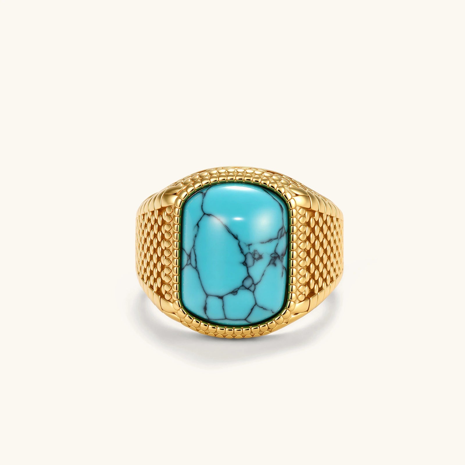 Gold PVD stainless steel signet ring with cushion faux turquoise stone and textured honeycomb band, front view.